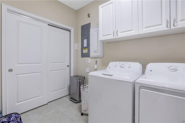 laundry area with cabinets, electric panel, and washer and dryer