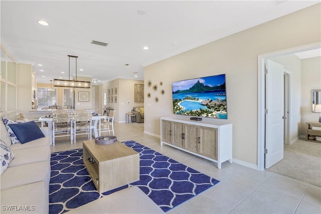 tiled living room with an inviting chandelier