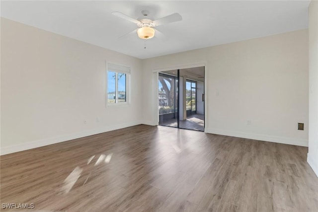 spare room featuring hardwood / wood-style floors and ceiling fan