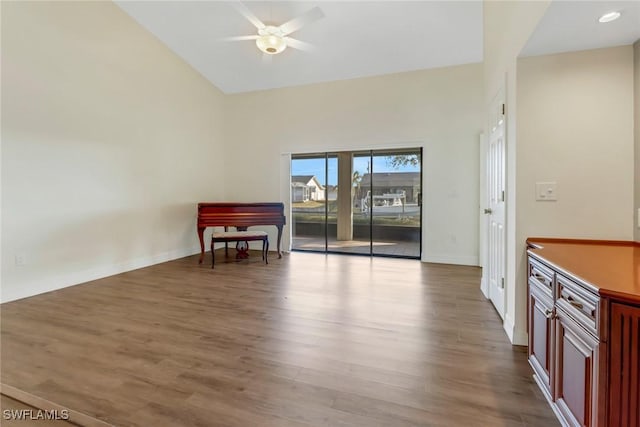 interior space with ceiling fan, high vaulted ceiling, and light hardwood / wood-style floors