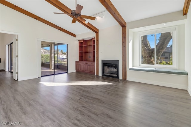 unfurnished living room featuring ceiling fan, lofted ceiling with beams, and dark wood-type flooring