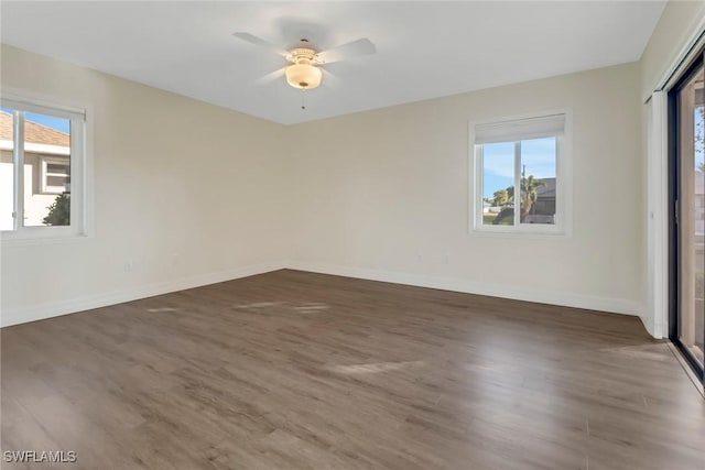 unfurnished room featuring ceiling fan and dark wood-type flooring