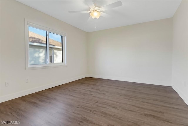 unfurnished room with ceiling fan and dark wood-type flooring