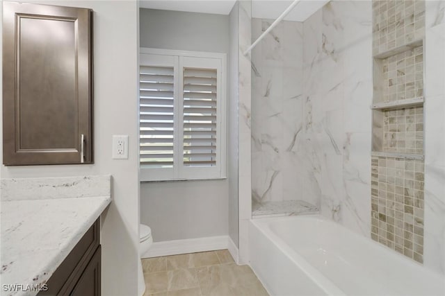 full bathroom with tiled shower / bath combo, vanity, and toilet