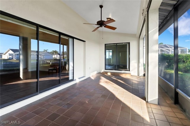 unfurnished sunroom with ceiling fan and lofted ceiling