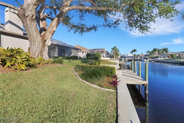 dock area featuring a yard and a water view