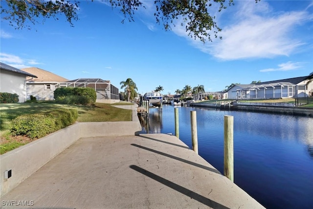 view of dock featuring a water view and a lawn