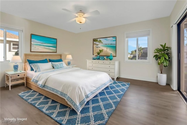 bedroom featuring multiple windows, ceiling fan, and dark hardwood / wood-style floors