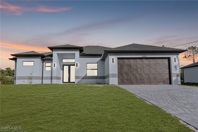 view of front facade with a lawn and a garage