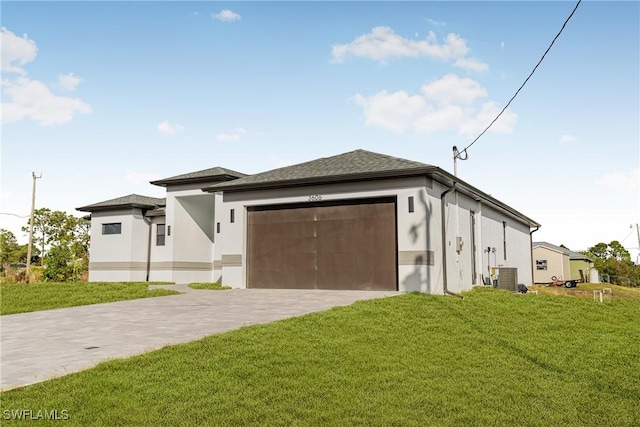 view of front of property with a front yard and a garage