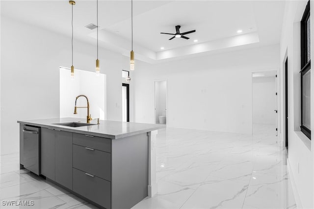 kitchen with pendant lighting, a tray ceiling, gray cabinets, and sink