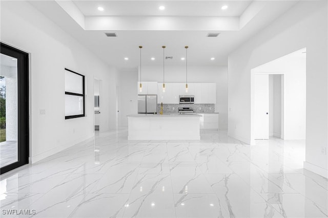 unfurnished living room with a raised ceiling