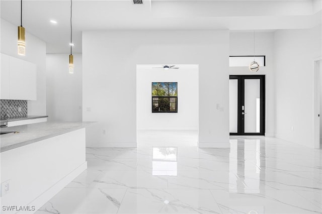 interior space with french doors and ceiling fan