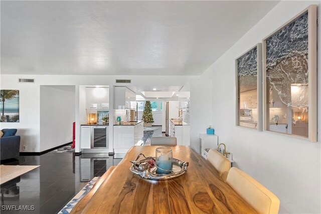 dining room featuring hardwood / wood-style flooring and wine cooler