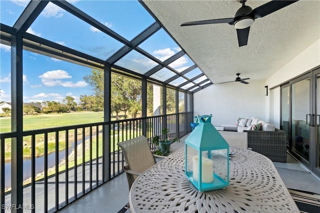 sunroom featuring a wealth of natural light and ceiling fan