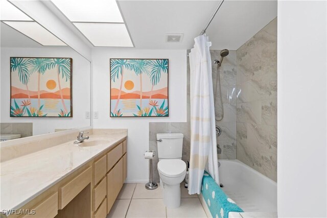 full bathroom with tile patterned floors, shower / tub combo, vanity, and toilet