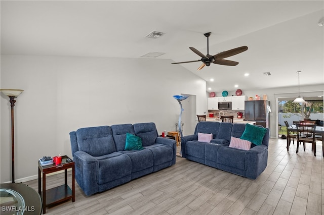 living room featuring lofted ceiling, light hardwood / wood-style floors, and ceiling fan