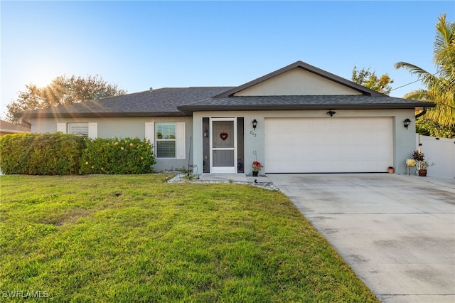 single story home featuring a garage and a front lawn