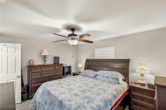 bedroom with ceiling fan and light wood-type flooring