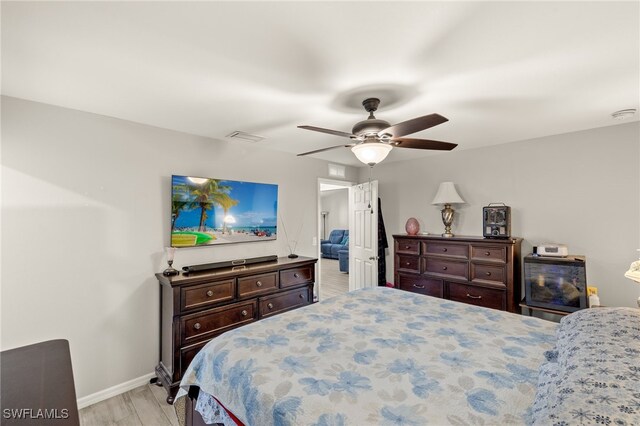 bedroom with ceiling fan and light hardwood / wood-style floors