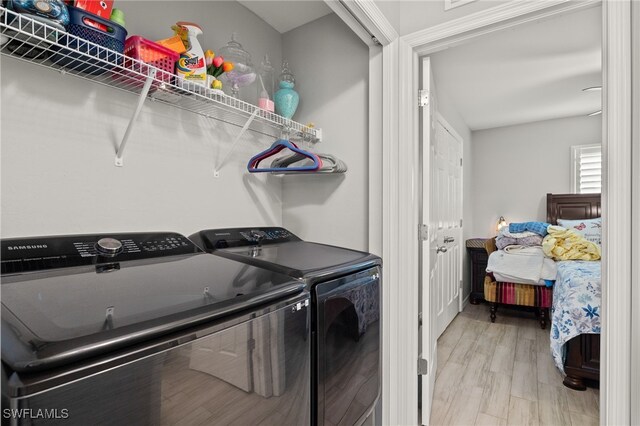 washroom featuring washer and dryer and light hardwood / wood-style flooring