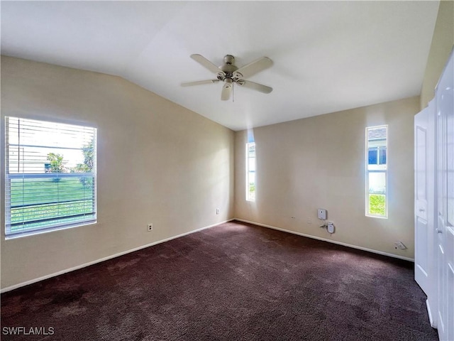 carpeted spare room with ceiling fan and lofted ceiling