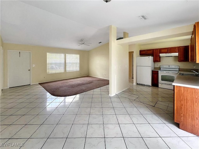 kitchen featuring ceiling fan, sink, lofted ceiling, white appliances, and light tile patterned floors