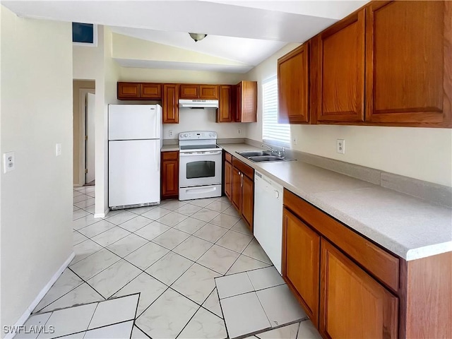 kitchen featuring light tile patterned flooring, white appliances, lofted ceiling, and sink