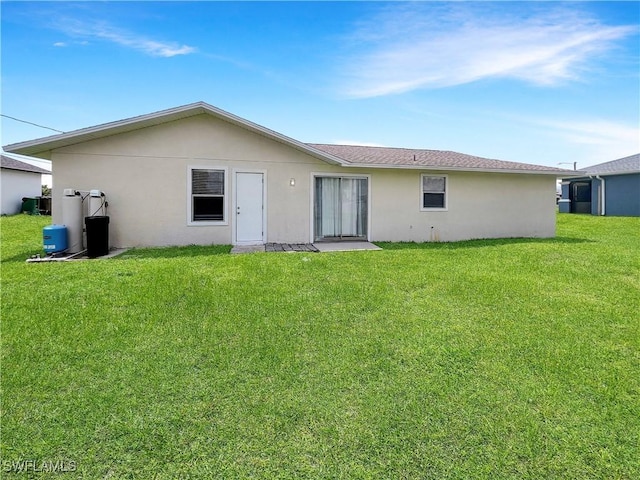 rear view of house with a lawn