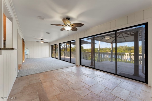 spare room featuring ceiling fan and a water view