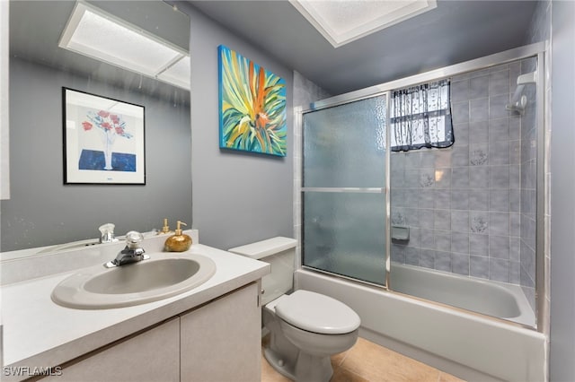 full bathroom with tile patterned flooring, vanity, toilet, and enclosed tub / shower combo