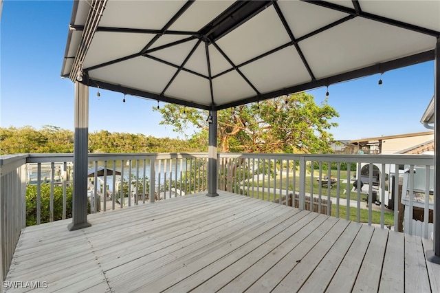 wooden terrace featuring a water view