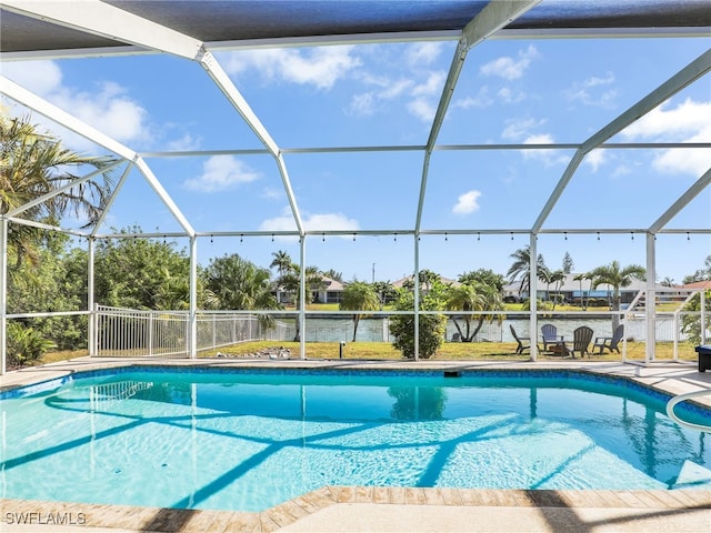 view of swimming pool featuring a patio, a water view, and glass enclosure