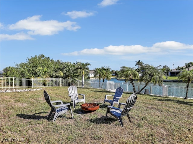 view of yard featuring a water view and a fire pit