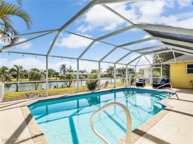 view of pool featuring glass enclosure, a patio area, and a water view