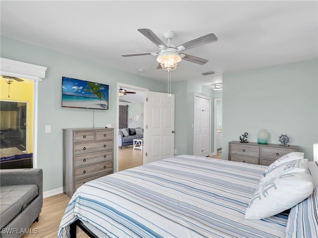 bedroom featuring ceiling fan, a closet, and light hardwood / wood-style floors