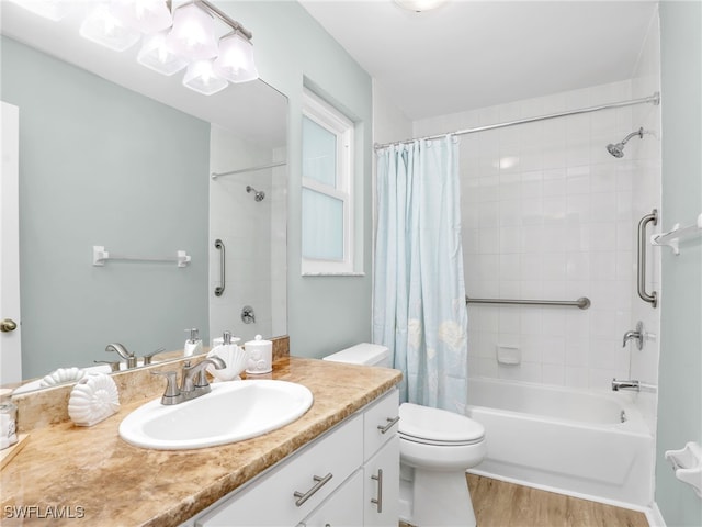 full bathroom with vanity, wood-type flooring, shower / bath combo, and toilet