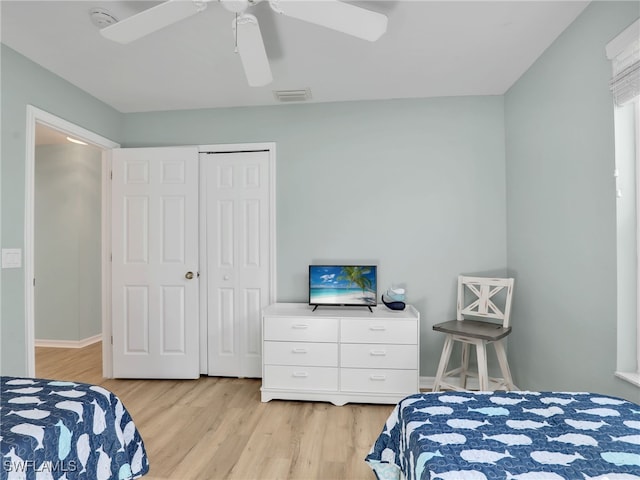 bedroom featuring a closet, ceiling fan, and light hardwood / wood-style floors