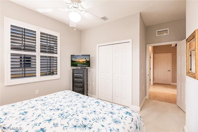 carpeted bedroom with a closet and ceiling fan