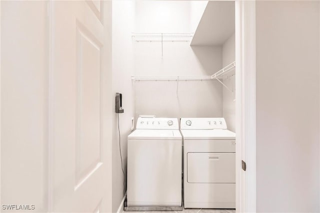 clothes washing area with washer and dryer