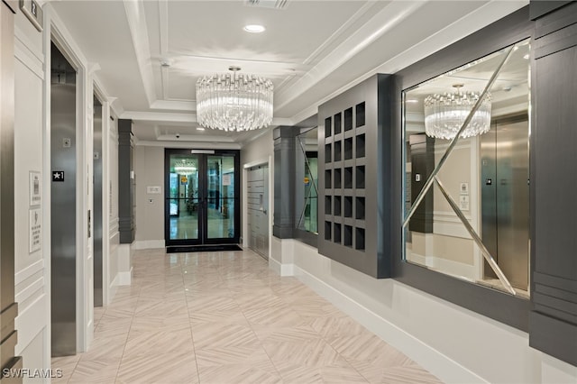 hallway featuring light tile patterned floors, ornamental molding, a tray ceiling, and an inviting chandelier