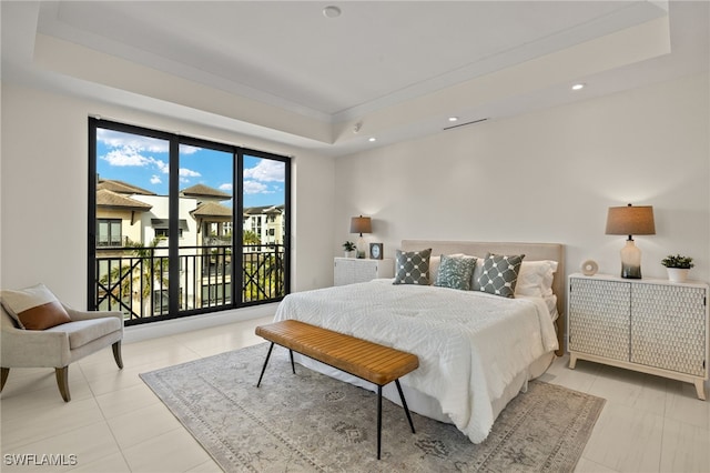 bedroom featuring a raised ceiling, light tile patterned floors, and access to outside