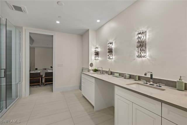 bathroom with tile patterned flooring, vanity, and walk in shower