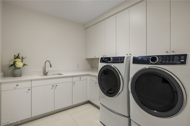 washroom featuring cabinets, light tile patterned floors, separate washer and dryer, and sink