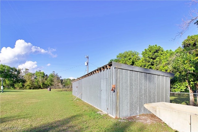 view of outbuilding featuring a yard