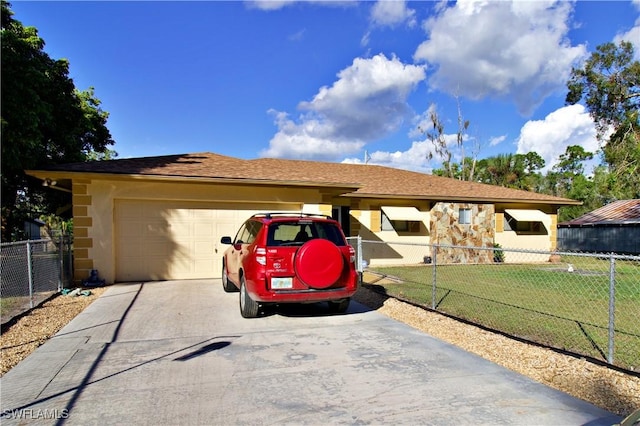 ranch-style house with a garage and a front lawn