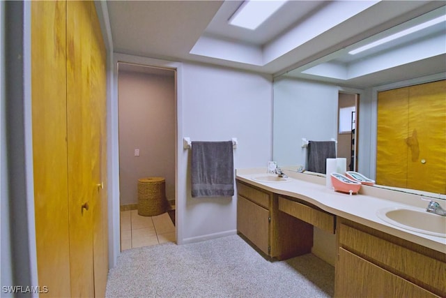 bathroom with tile patterned flooring and vanity