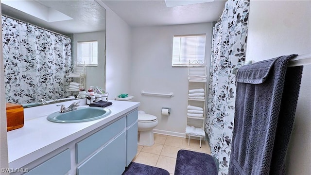 bathroom with toilet, vanity, tile patterned floors, and a shower with shower curtain