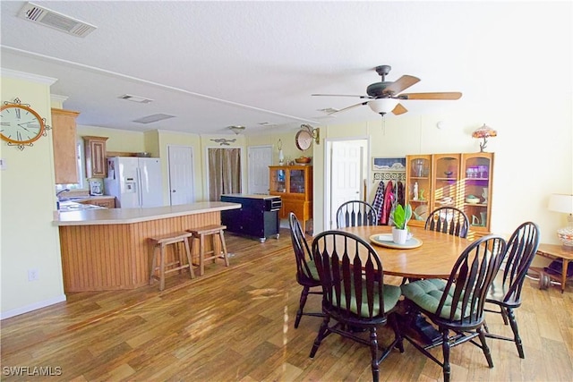 dining space featuring light hardwood / wood-style floors and ceiling fan