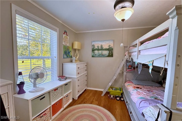 bedroom featuring dark wood-type flooring and ornamental molding